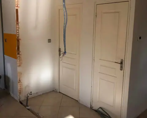 Une rénovation : murs refaits en plaques autour de deux portes existantes